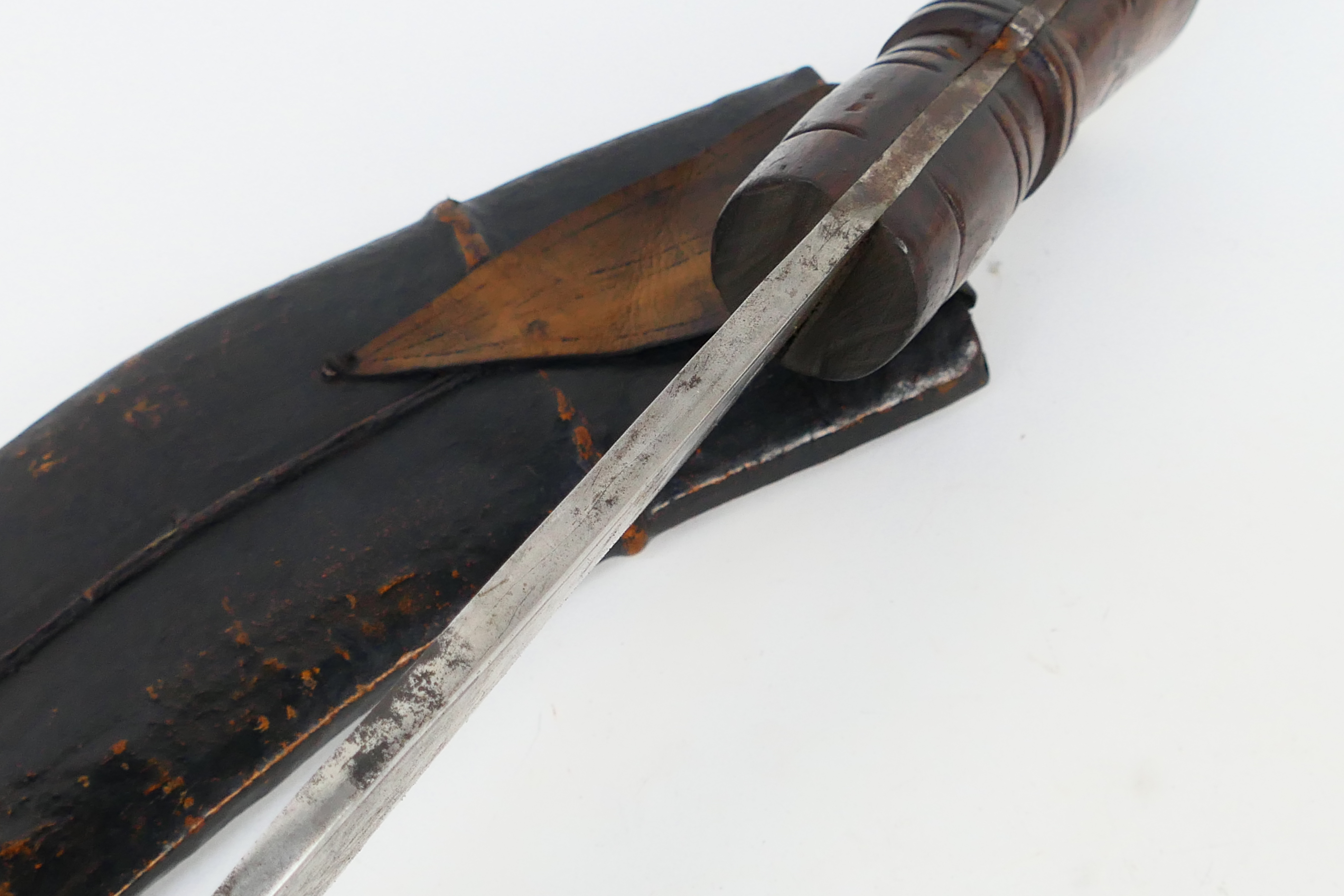 A Gurkha kukri knife, dated 1916, turned wooden hilt with metal pommel, housed in leather sheath. - Image 6 of 9