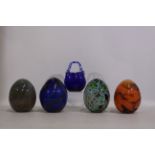 4 x unique egg-shaped glass items with interesting patterns.
