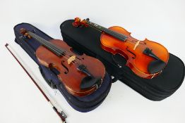 Two cased violins, each approximately 51 cm (l), one with bow.