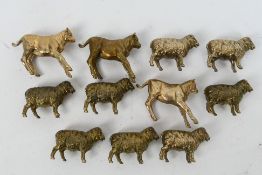 Eight bronze sheep figures, approximately 3 cm (l) and three calf figures approximately 4 cm (l).