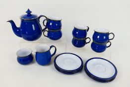 Denby - An Imperial Blue tea set comprising teapot, milk jug, sugar bowl and six cups and saucers.