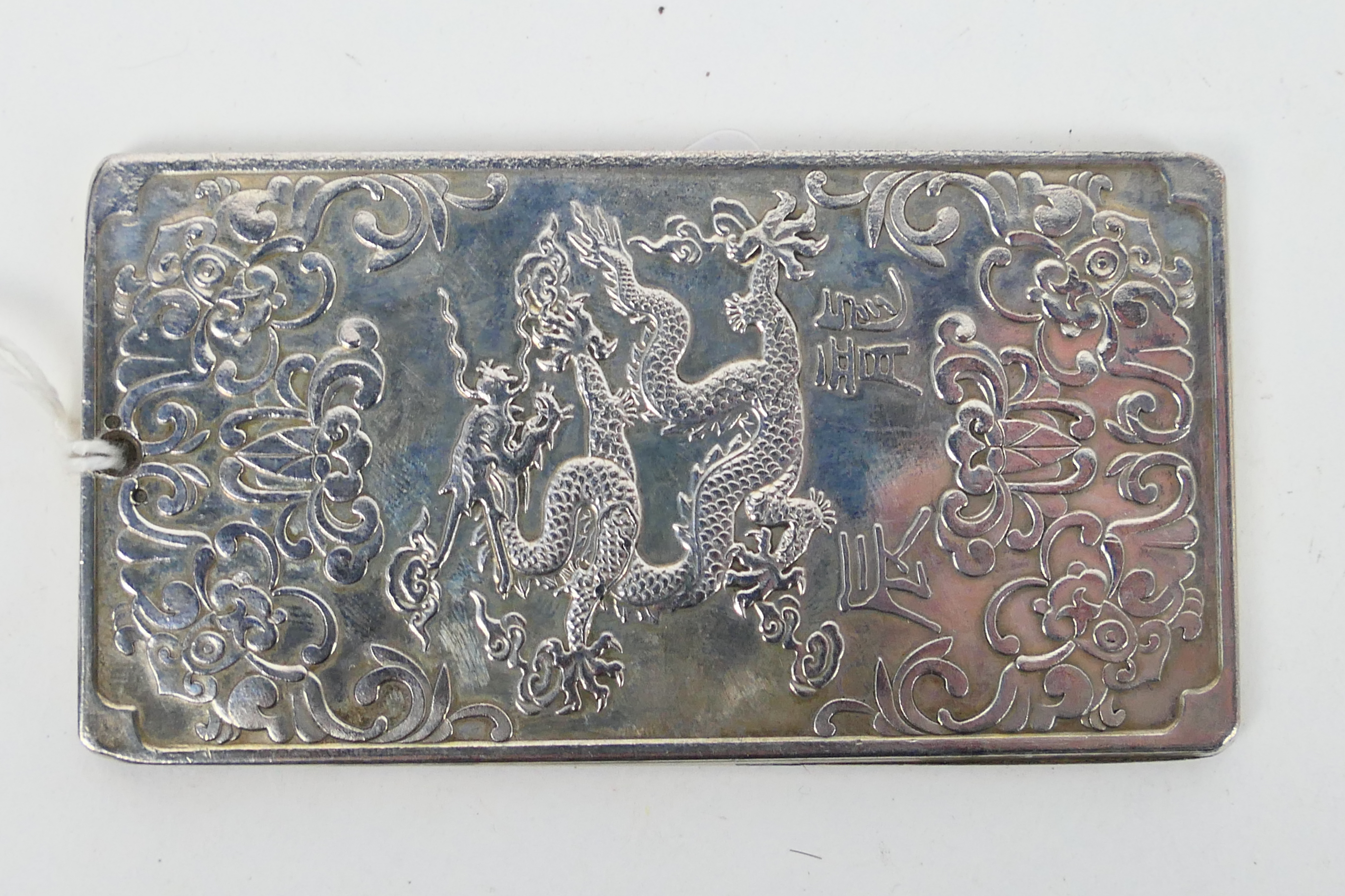 A Chinese white metal (presumed silver) ingot / plaque with depiction of a five clawed dragon to - Image 2 of 3