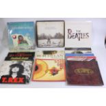 A collection of 12" vinyl records to include Bob Dylan, The Beatles, Kate Bush, The Rolling Stones,