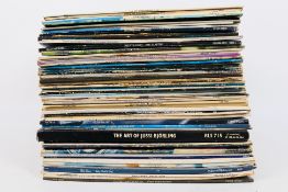 A collection of 12" vinyl records to include Elton John, Rod Stewart, ELO, Simon & Garfunkel,