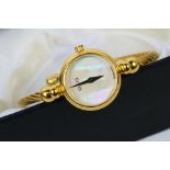 A Gucci bangle wristwatch, the circular mother of pearl dial with dauphine hands,