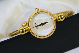 A Gucci bangle wristwatch, the circular mother of pearl dial with dauphine hands,