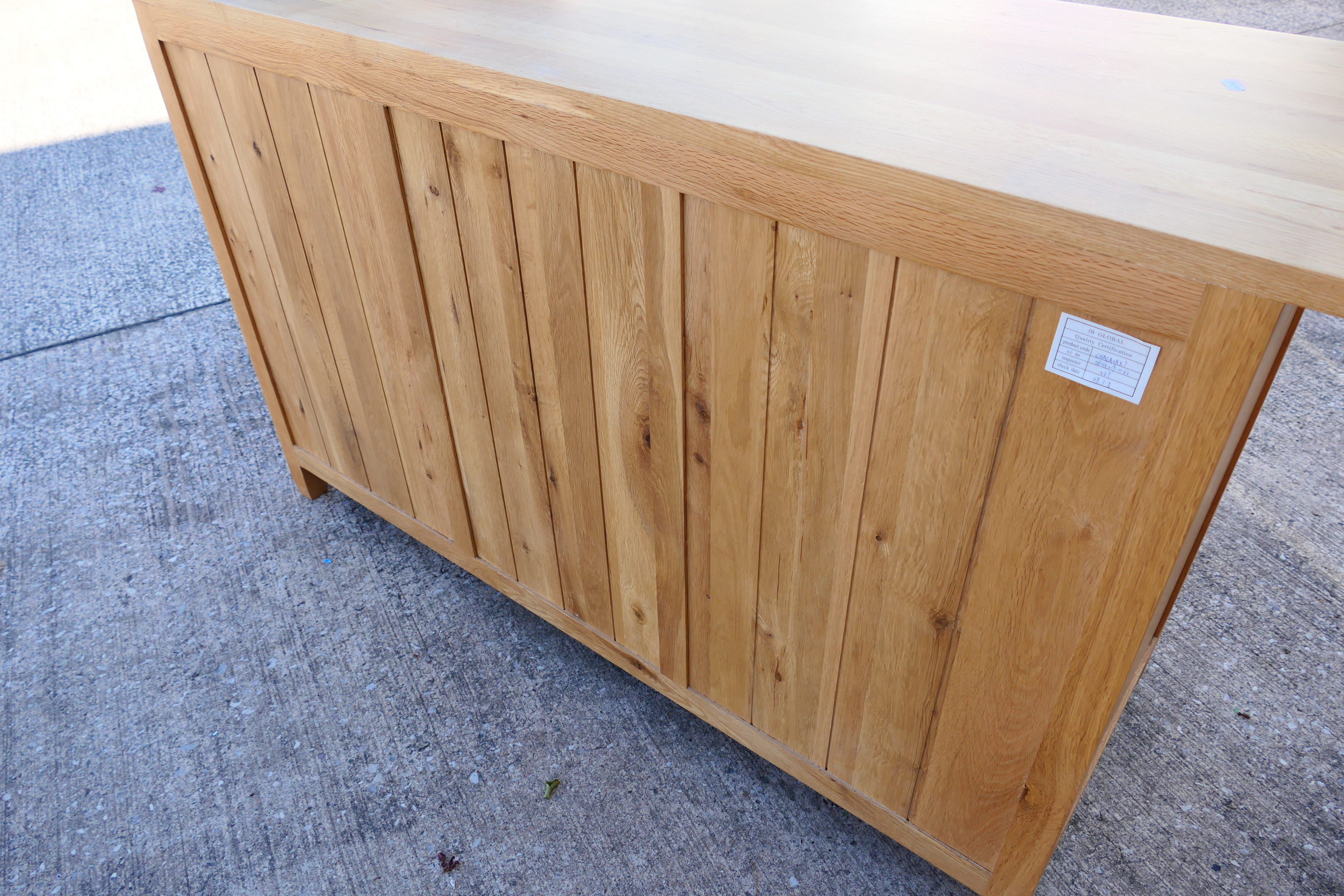 A light oak sideboard with four central, graduated drawers flanked by single door cupboards, - Image 5 of 6