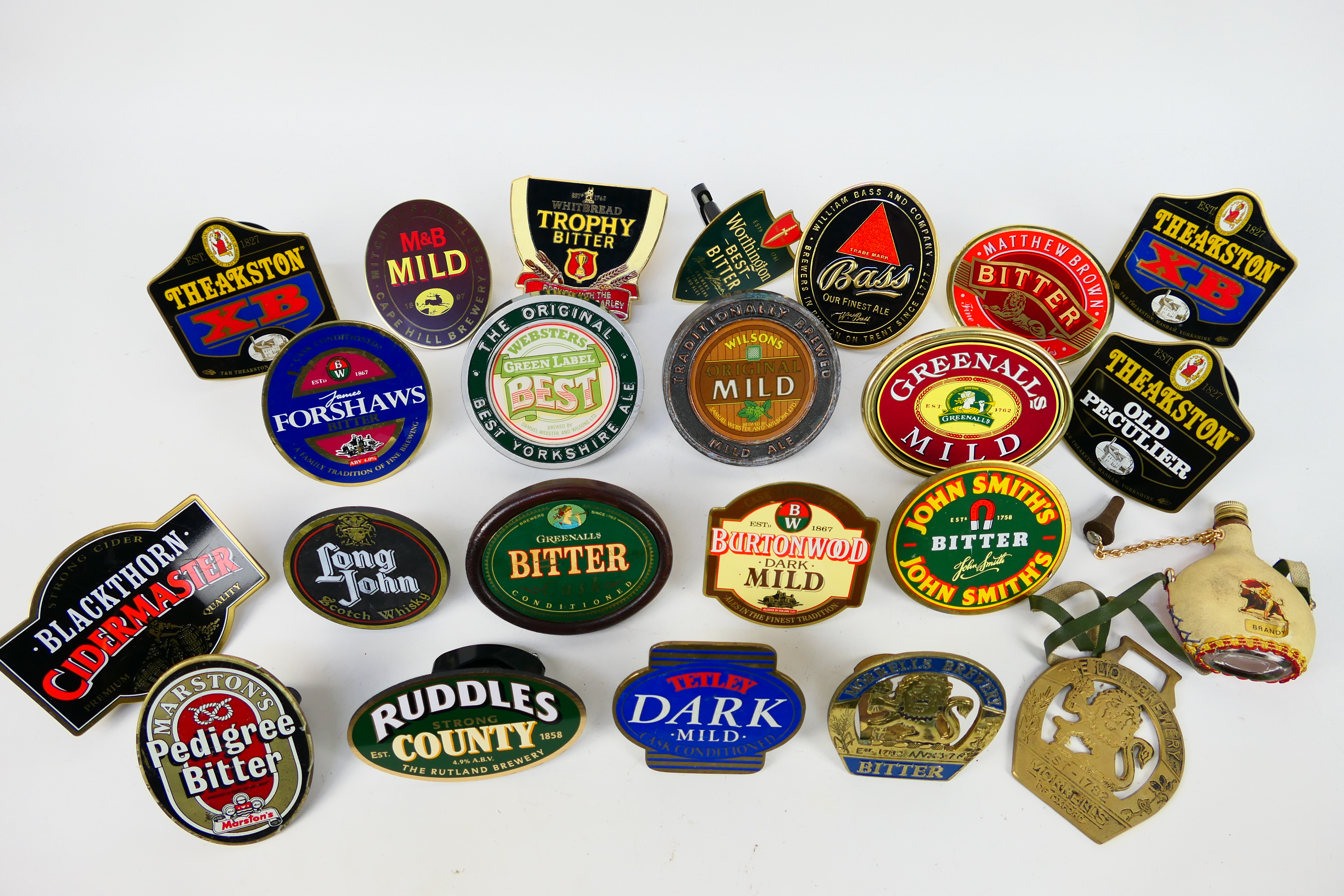 A good collection of bar top pump clips, predominantly brass.