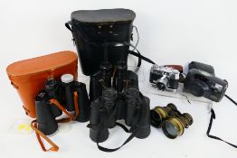 A small collection of cameras, binoculars / field glasses.