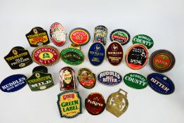 A good collection of bar top pump clips, predominantly brass.