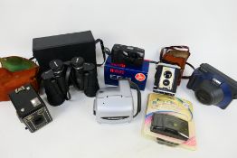 Photography - Vintage cameras and a pair of binoculars.