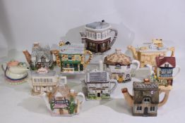 A collection of novelty teapots to include The Rovers Return, The Woolpack and The Queen Victoria,