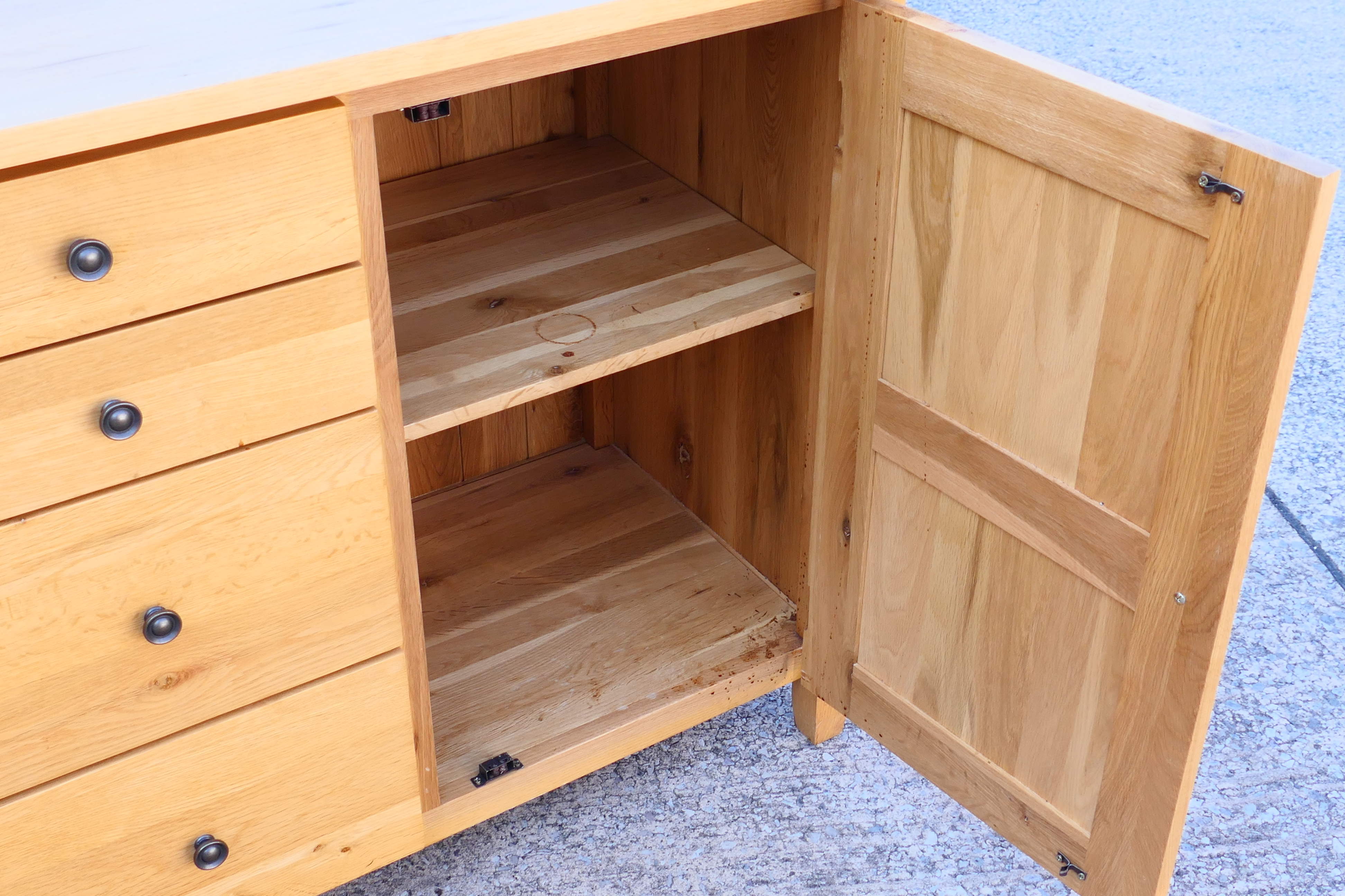 A light oak sideboard with four central, graduated drawers flanked by single door cupboards, - Image 3 of 6