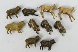 Eight small bronze sheep figures largest approximately 4 cm (l) and two calf figures.
