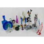 A collection of glass fish, clown, paperweights to include Mdina,