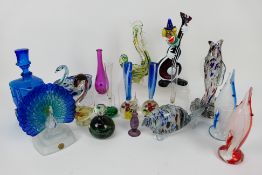 A collection of glass fish, clown, paperweights to include Mdina,
