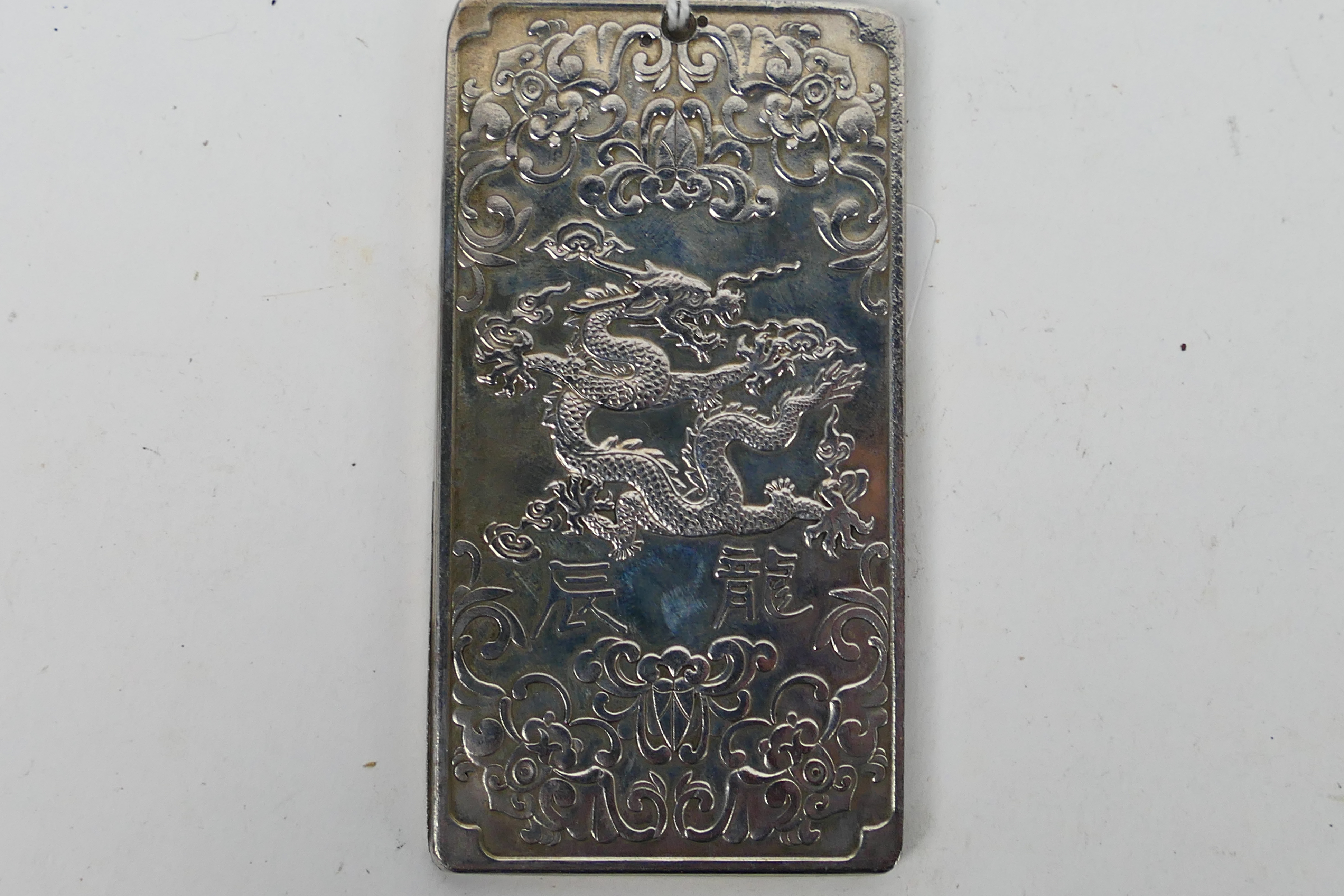 A Chinese white metal (presumed silver) ingot / plaque with depiction of a five clawed dragon to - Image 3 of 3