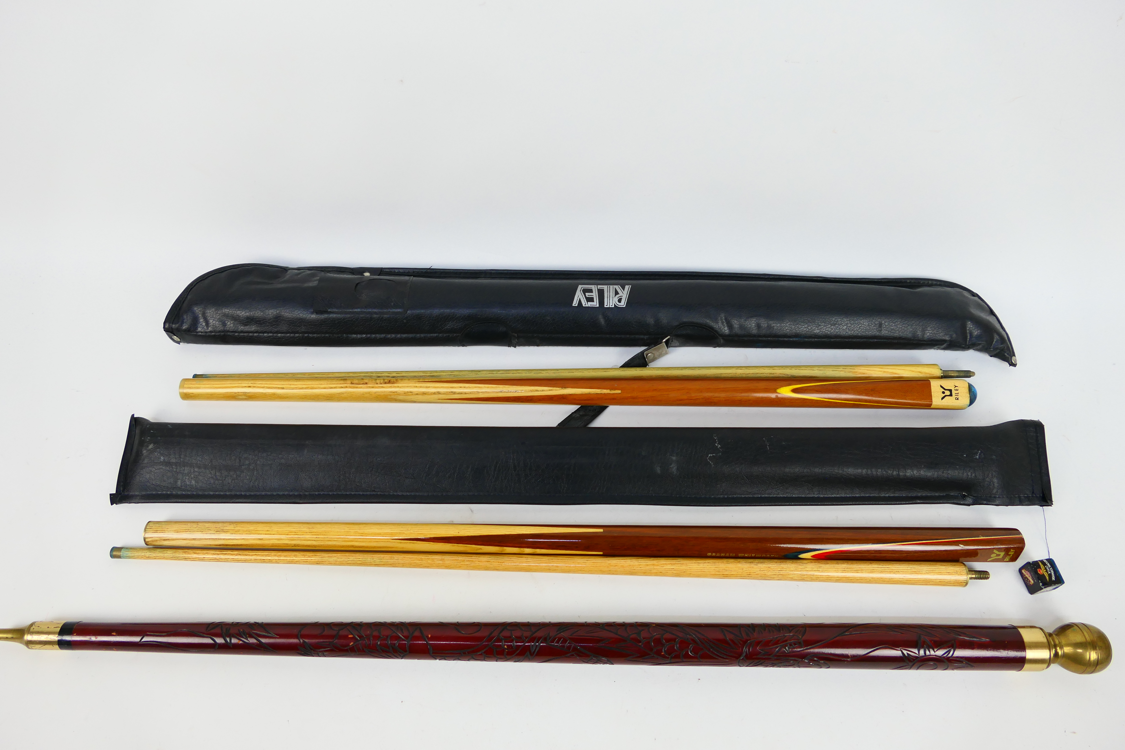 Three vintage pool cues comprising two Riley examples,