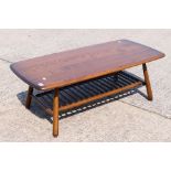 An Ercol coffee table with spindle undertier, approximately 36 cm x 104 cm x 50 cm.