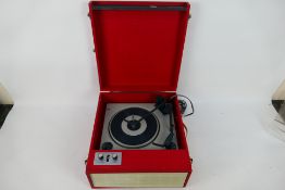 A vintage Fidelity portable record player in red and white case.