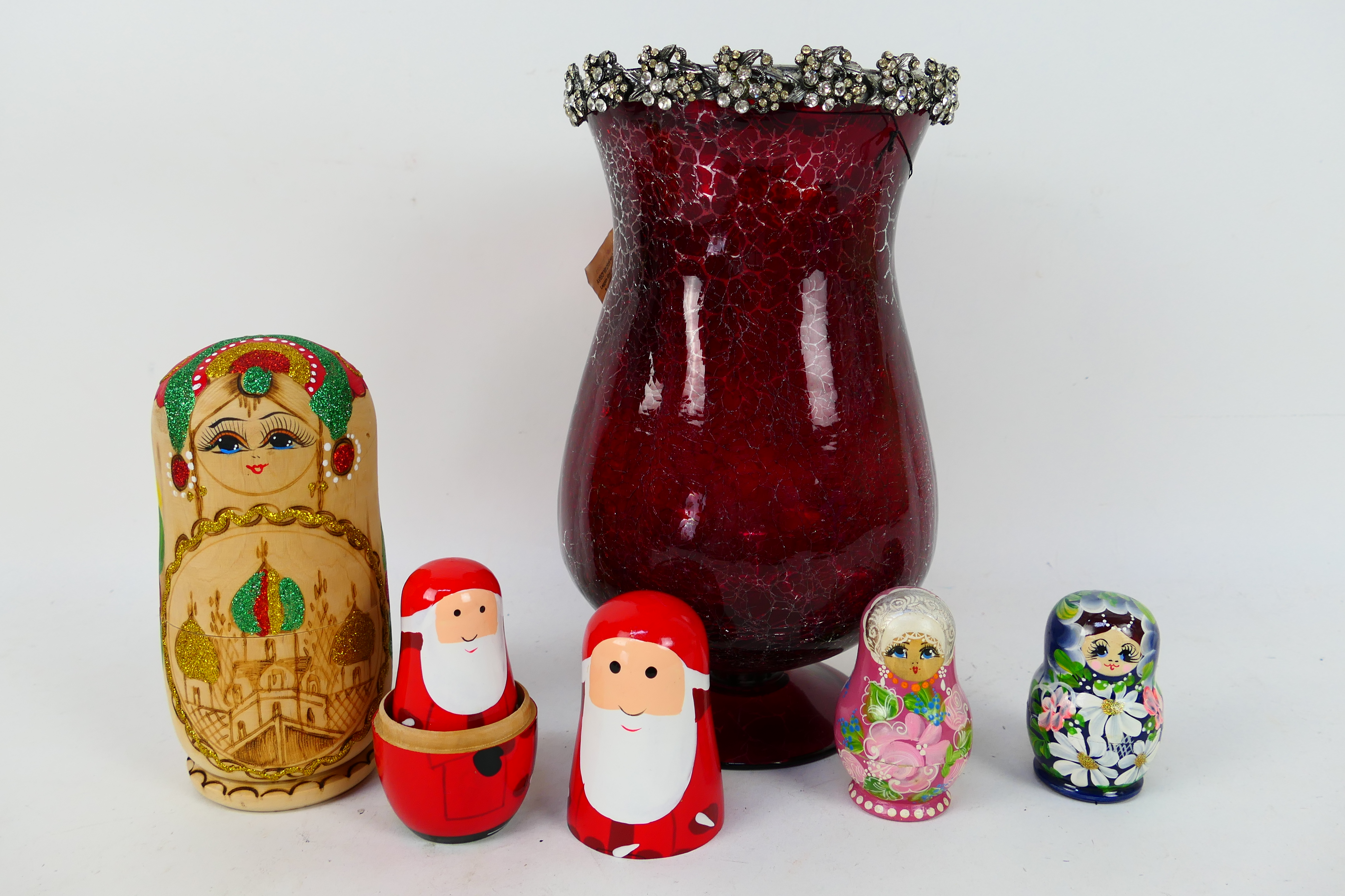 A decorative windlight candle holder, 30 cm (h) and four set of Russian matryoshka nesting dolls,