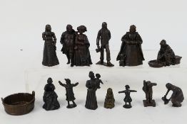A collection of bronze figures to include Victorian style, servants, children and other,