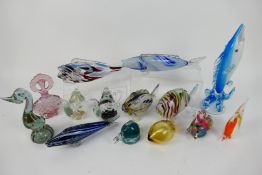 A collection of glassware to include Murano style fish, paperweights, Murano bird,