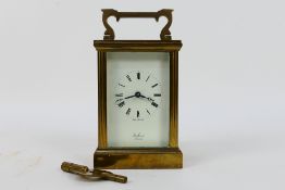 A 20th century English 8 day carriage clock, brass case, white dial signed St James London,