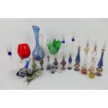 A collection of various glassware to include Egyptian perfume bottles, paperweights,