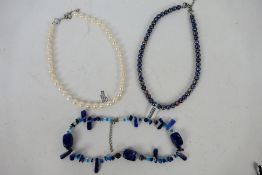 A black pearl necklace, a lapis lazuli n