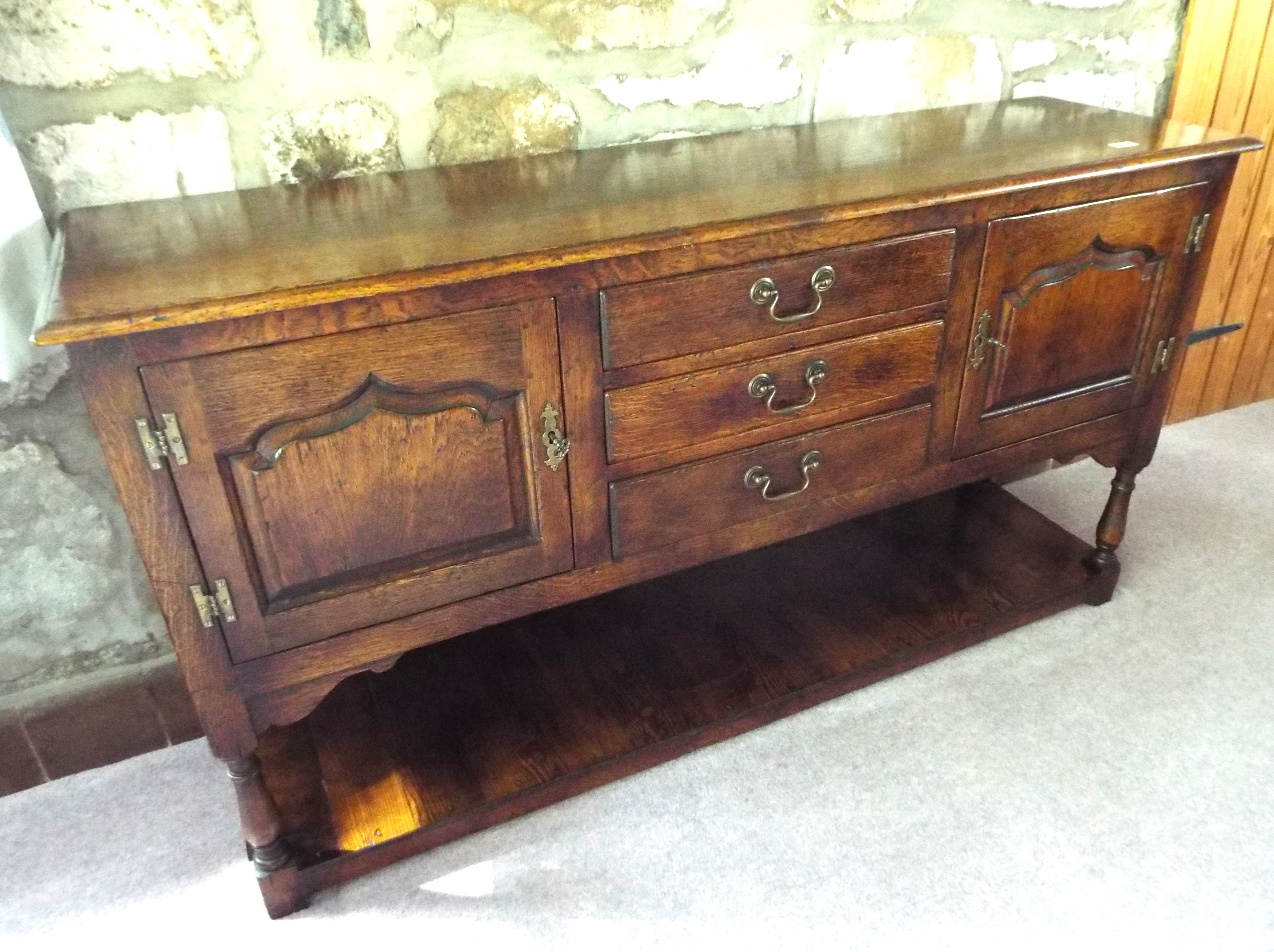 A good dark oak sideboard retailed by Ar