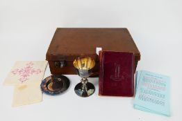 A silver plated communion set and book o