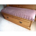 An Ottoman with pink upholstered top mea