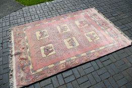 A large rug with animal decoration to include elephant, camel and other,