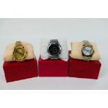 Three boxed fashion watches to include Emporio Armani. [3].