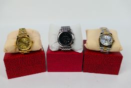 Three boxed fashion watches to include Emporio Armani. [3].