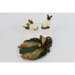 Two Siamese cat figures / groups, one Beswick, one Royal Doulton, largest 10.