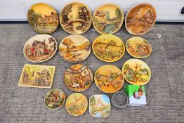 A collection of plaster wall plaques, predominantly circular, largest approximately 37 cm (d). [2].