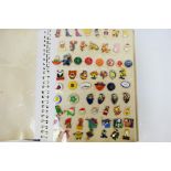 A large quantity of pin badges, mounted in a photograph album, to include Arsenal football club,