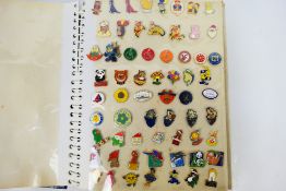 A large quantity of pin badges, mounted in a photograph album, to include Arsenal football club,