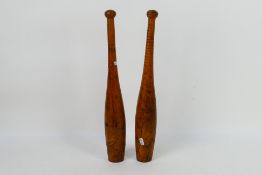 A pair of late Victorian / Edwardian Indian or exercise clubs with weighted ends and knop finials,