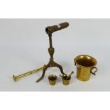 A 19th century brass goffering / tally iron raised on tripod serpentine supports,