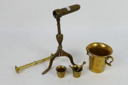 A 19th century brass goffering / tally iron raised on tripod serpentine supports,