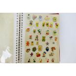 A collection of various pin badges to include US postage stamps, Disney, Mr Men, Nintendo,