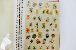 A collection of various pin badges to include US postage stamps, Disney, Mr Men, Nintendo,