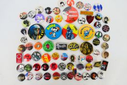 A collection of vintage pin badges, predominantly music / band related to include The Clash,