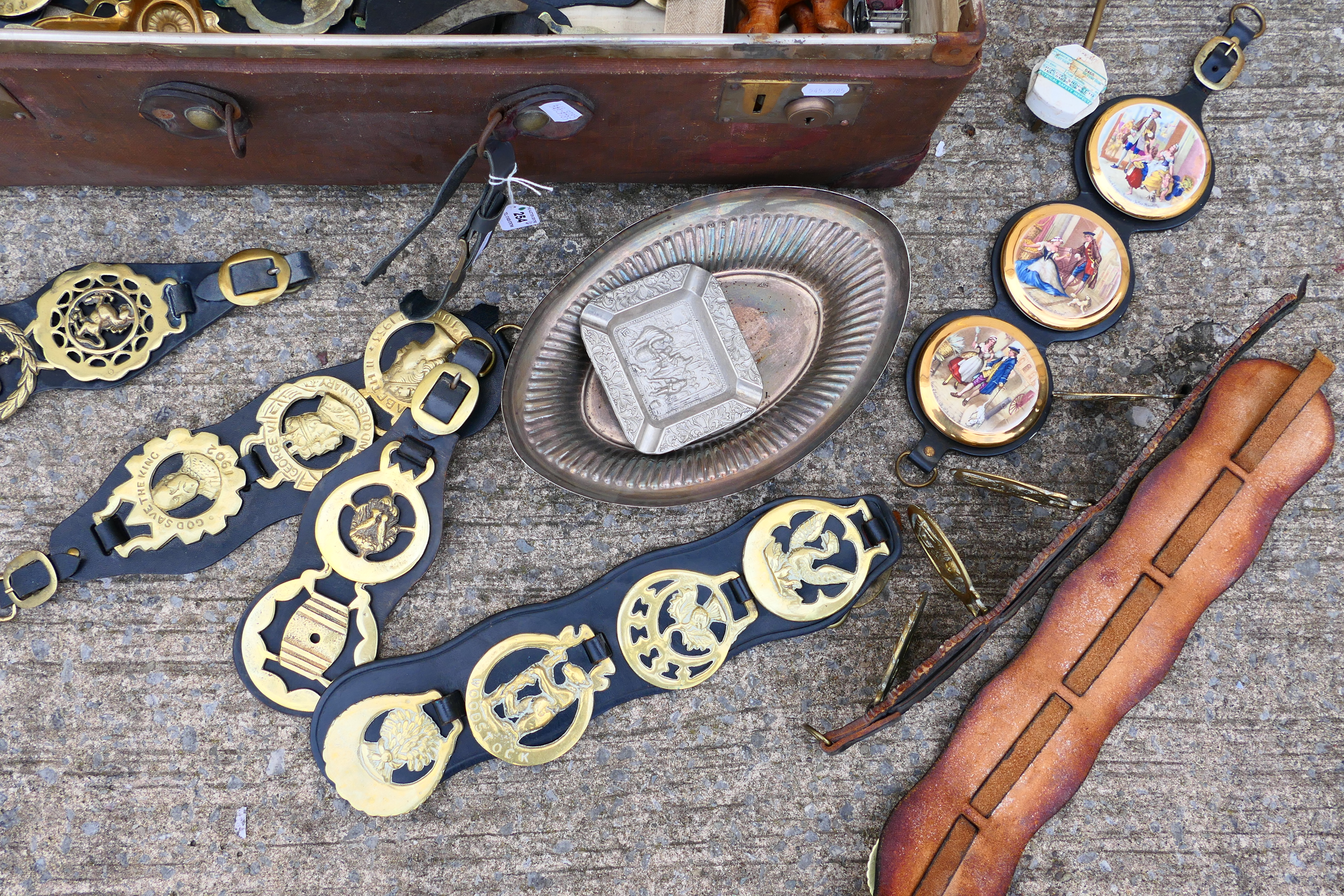 A vintage suitcase containing a quantity of various horse brasses, ships wheel nutcracker, - Image 4 of 6