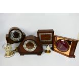 A collection of clocks to include mantel clocks and a torsion clock.