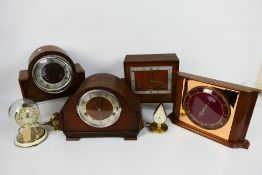 A collection of clocks to include mantel clocks and a torsion clock.