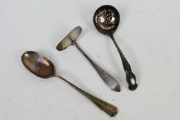 A hallmarked silver spoon, pusher and strainer, various assay marks, approximately 66 grams / 2.